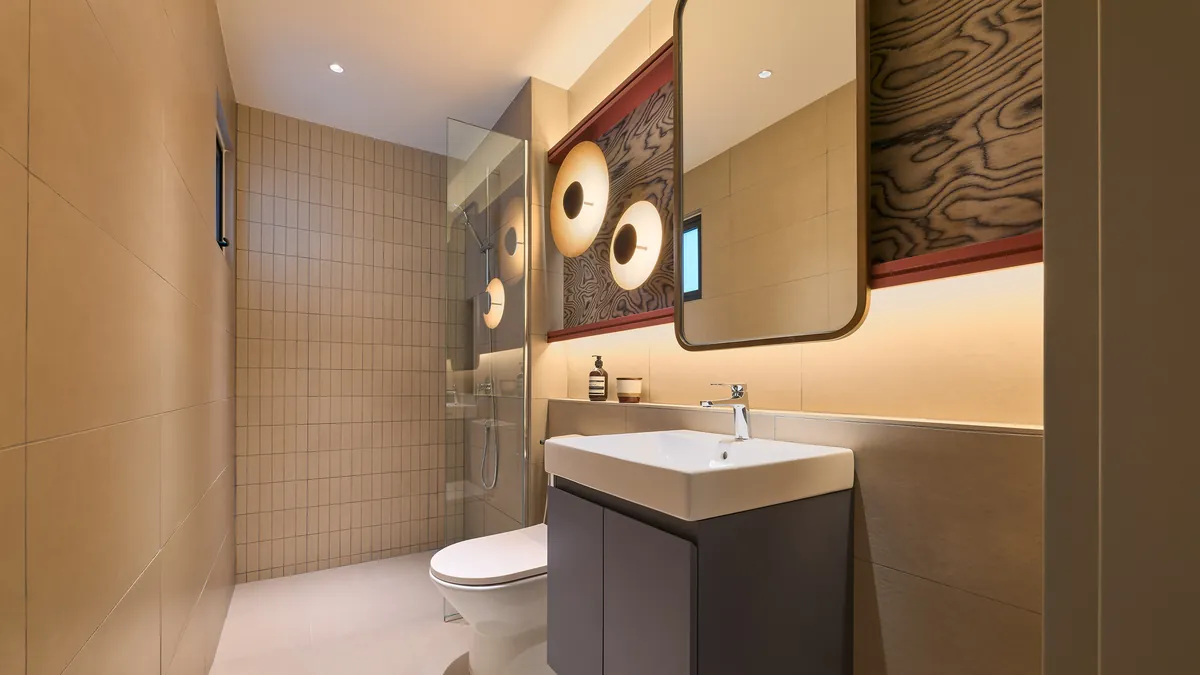 Type A bathroom vanity in grey with warm wall tile